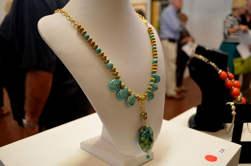 Paintings aren’t the only items on display at the juried exhibit. Other items include photographs, and jewelry, like this necklace by Sue Reese.