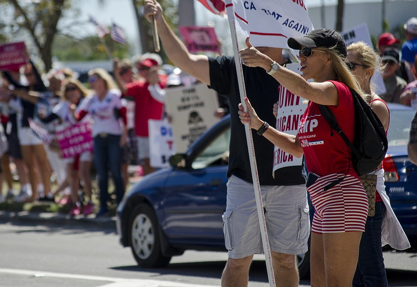 Caroline Jensen gives a thumbs up to a passing motorist.