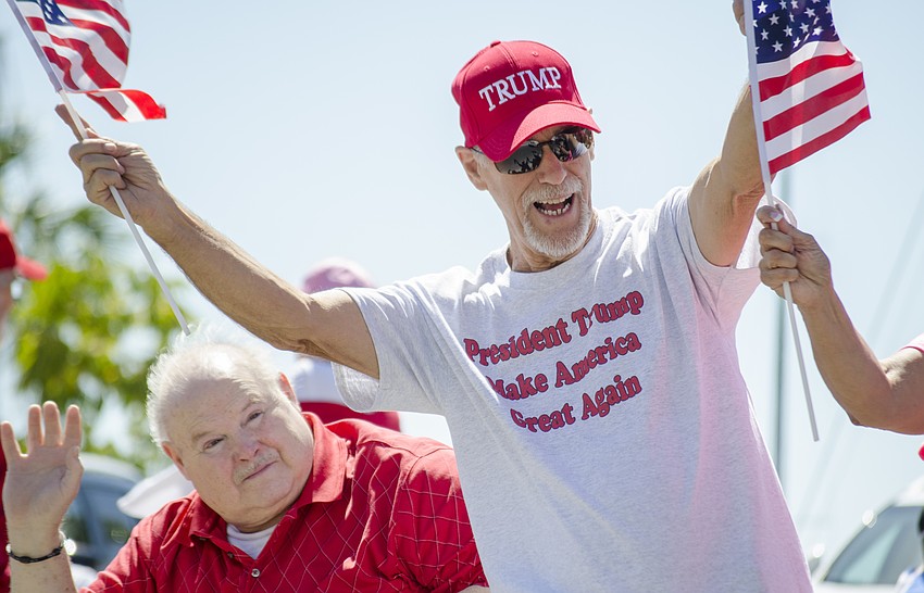 Jeff Dwyer reacts to a show of approval from a passing motorist.