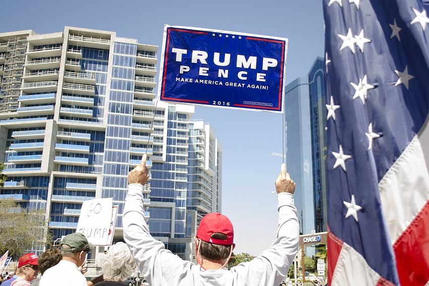 A demonstrator holds a Trump campaign sign during the Spirit of America Rally.