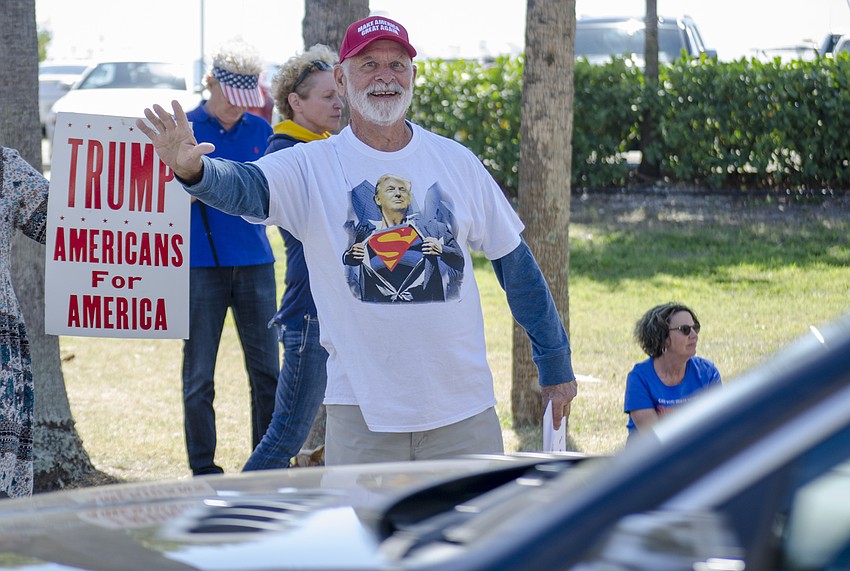 Walter Rock waves to a passing motorist during the Spirit of America Rally.