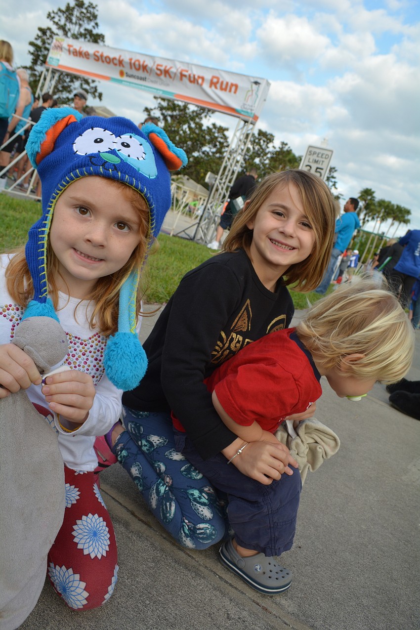 Lakewood Ranch'  s Emeline, Layla and Elliot Koreneman urge their mom forward in the 10K.