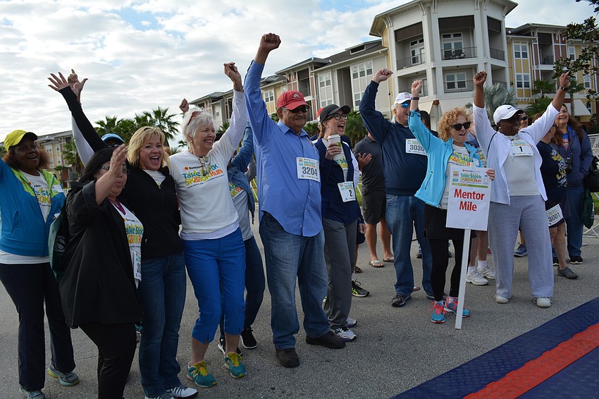 Manatee County Public School District employees, school board members and program mentors start their one-mile walk.