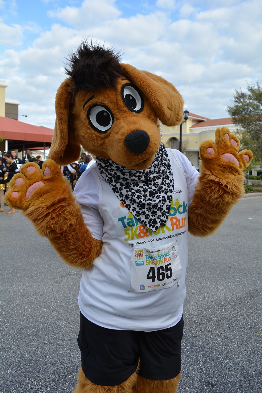 The Tod Puppy mascot greets guests and runners.