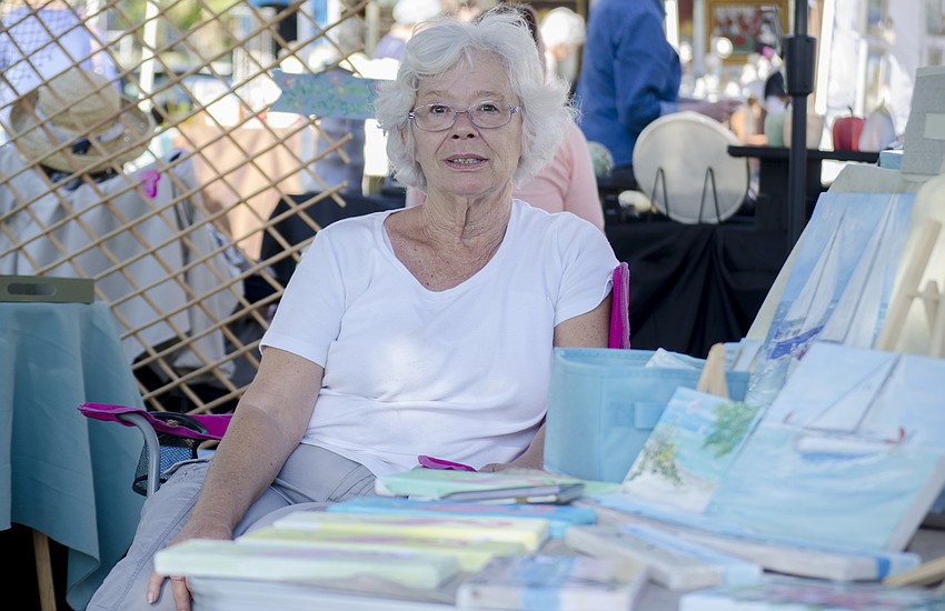 Karalee Hammes poses in her booth.