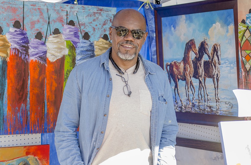 Tom Ruthz poses in his booth