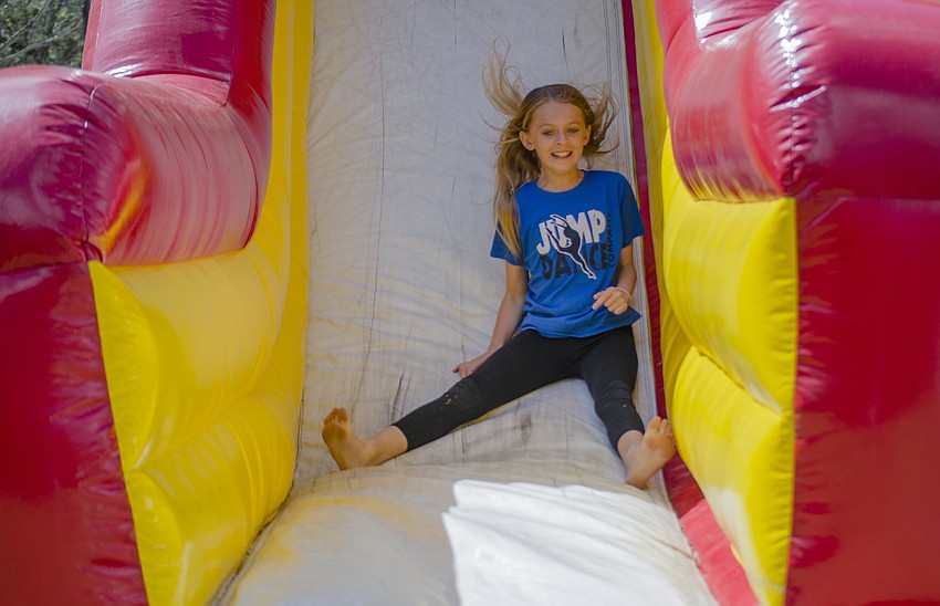 Ava Chyorny slides down an inflatable obstacle course.