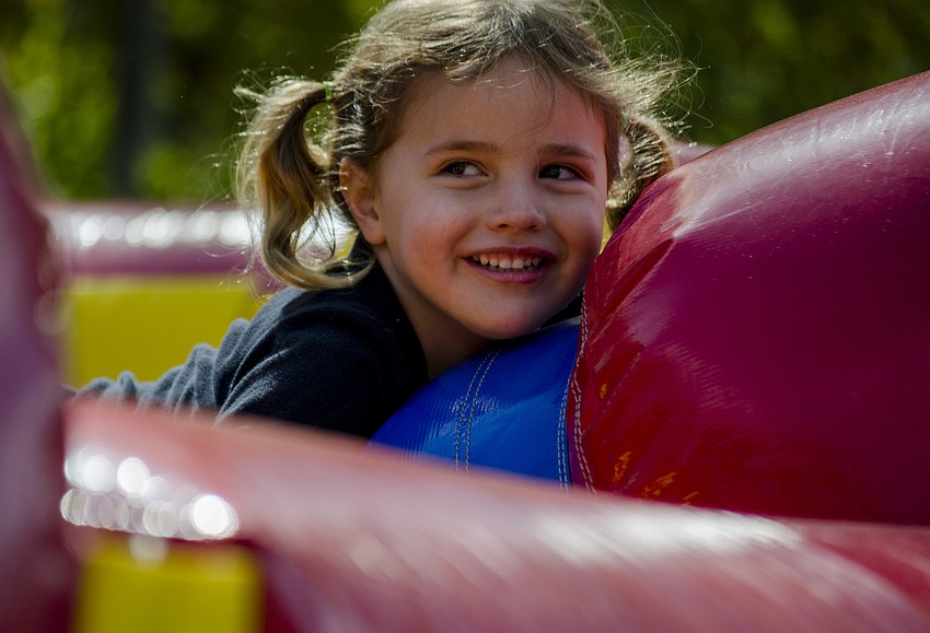 Violet Navas climbs through an inflatable obstacle course.