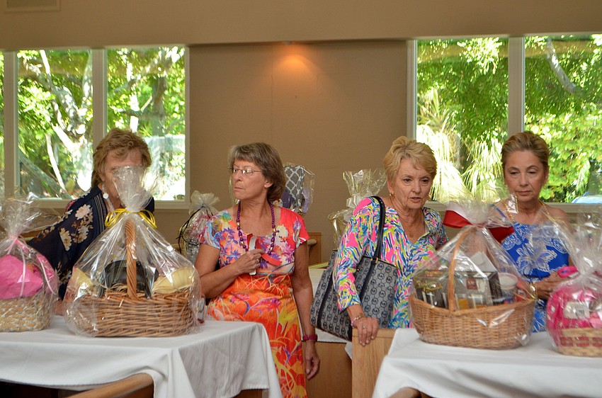Fashion show attendees peruse the raffle and silent auction items that were displayed in the chapel.