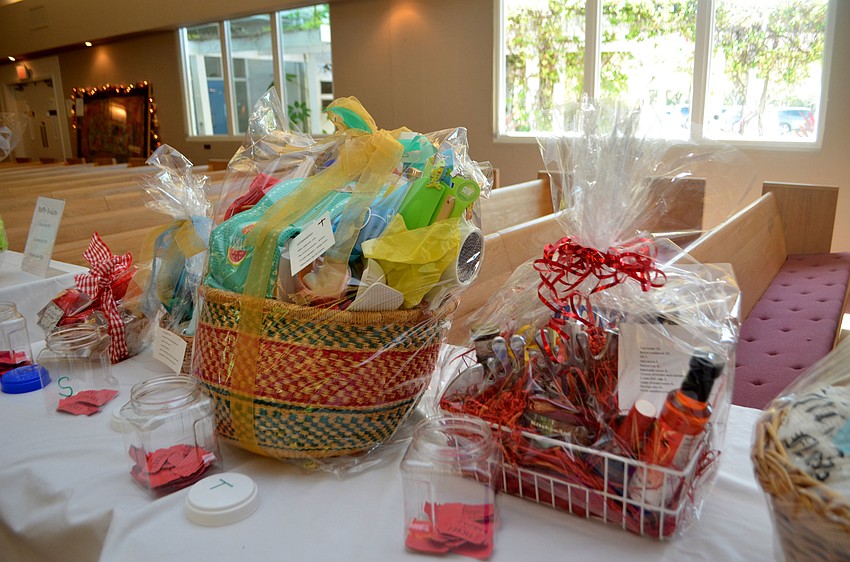 Raffle and silent auction items lined the chapel, so as attendees entered the fashion show, they could check out the baskets and bid on their favorites.