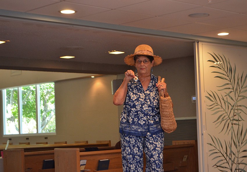 Shirley Bretches shows off a hand-crafted necklace.