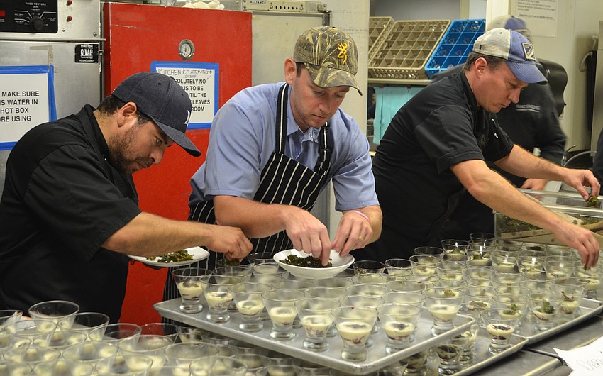 Darwin Santa Maria, Derek Blackburn and Erik Walker plate the first course together on March 10 at Michael’s On East.