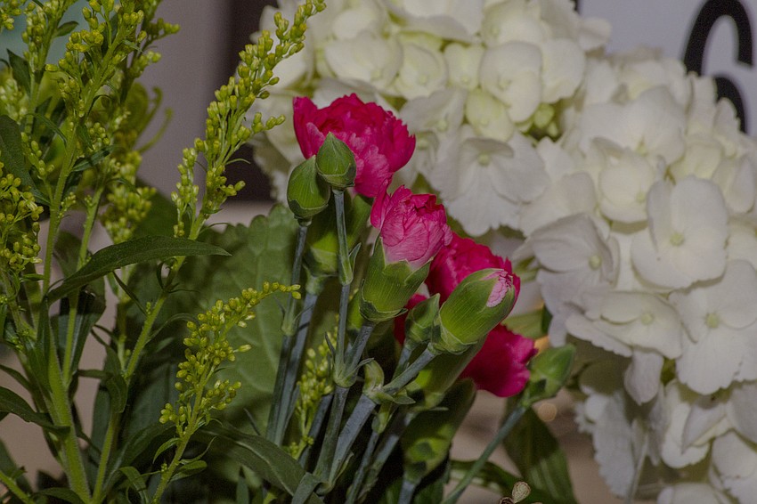 Green, pink and white flowers decorated the tables.