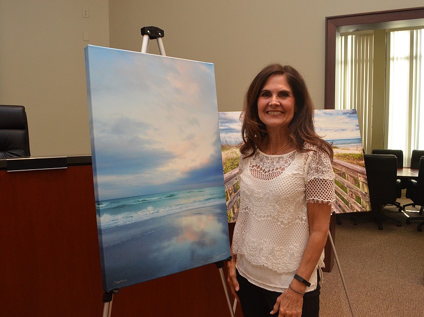 Mary Lou Johnson poses with her photographs.
