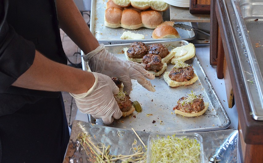 PJ Roth makes sliders at the Michael’s On East table at Party on the Pass: “Hot Night in Old Havana” on March 24 at Mote Marine Laboratory & Aquarium.