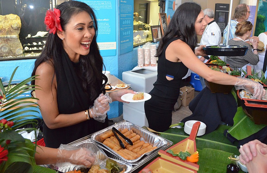 Kita Tiam of Pacific Rim serves guests at Party on the Pass: “Hot Night in Old Havana” on March 24 at Mote Marine Laboratory & Aquarium.