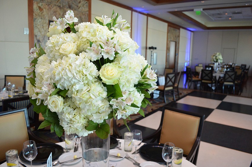 Tables were adorned with large white rose centerpieces at Miracle Ball on March 25 at Sarasota Yacht Club.