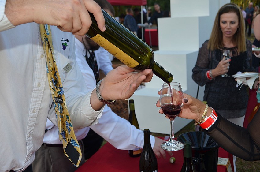 Tyler Haas pours a glass of Pisano Tannant RPF from Uruguay at the 5th annual Wine Walk to Ca’ d’Zan on March 31 at The Ringling.