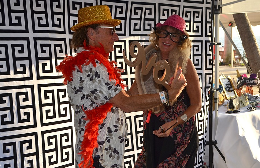 Joel Fried and Susan Decker laugh before posing in the Fancy Booth photo booth at the 5th annual Wine Walk to Ca’ d’Zan on March 31 at The Ringling.