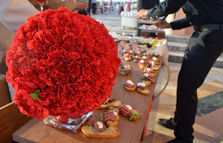 Modern Events employees serve beef tenderloin carpaccio at the 5th annual Wine Walk to Ca’ d’Zan on March 31 at The Ringling.