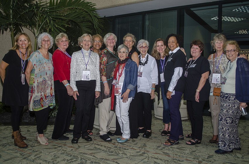 Through Women' s Eyes patrons and volunteers pose at the Through Women' s Eyes reception.