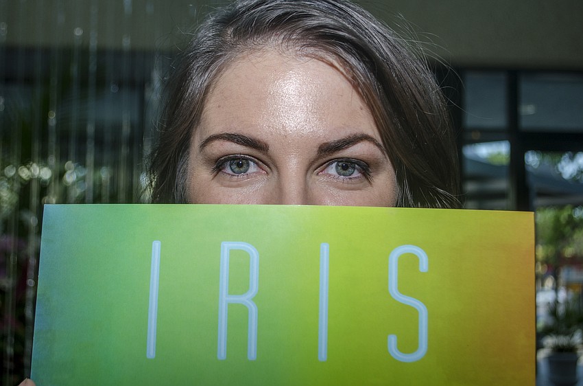 Nikki Lee poses with her short film poster at the Through Women' s Eyes reception.