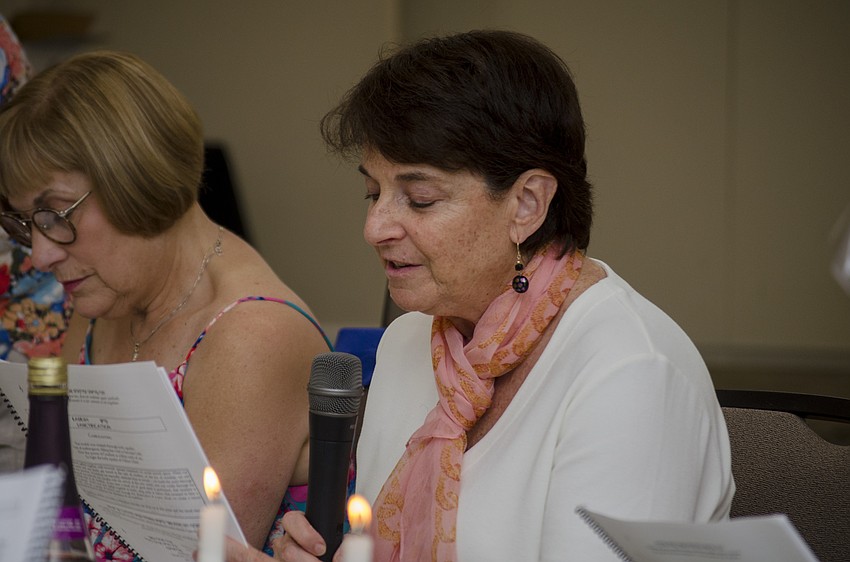 Wendy Damoulakis reads during the ceremonial meal.