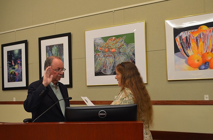 Town Clerk Trish Granger swears in Randy Clair on Monday to fill the District 1 seat.