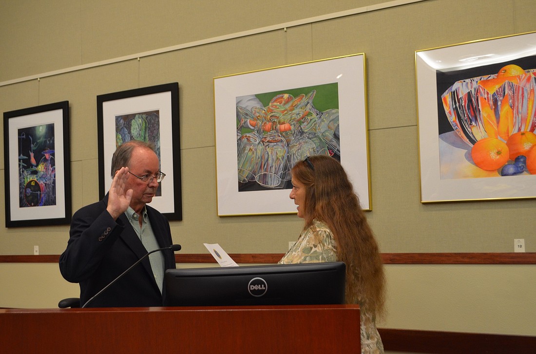 Town Clerk Trish Granger swears in Randy Clair on Monday to fill the District 1 seat.