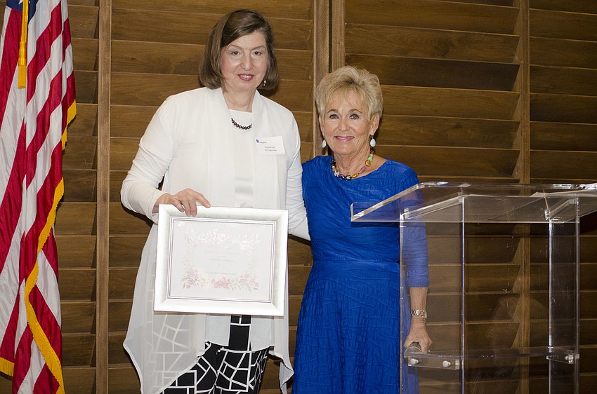 Susanne Schuenke and Compeer Founder Bunny Skirboll with Schuenke’s gift — a plant of her choice from Marie Selby Botanical Gardens — for offering her artwork for the raffle at the Compeer Luncheon on April 6 at The Francis.