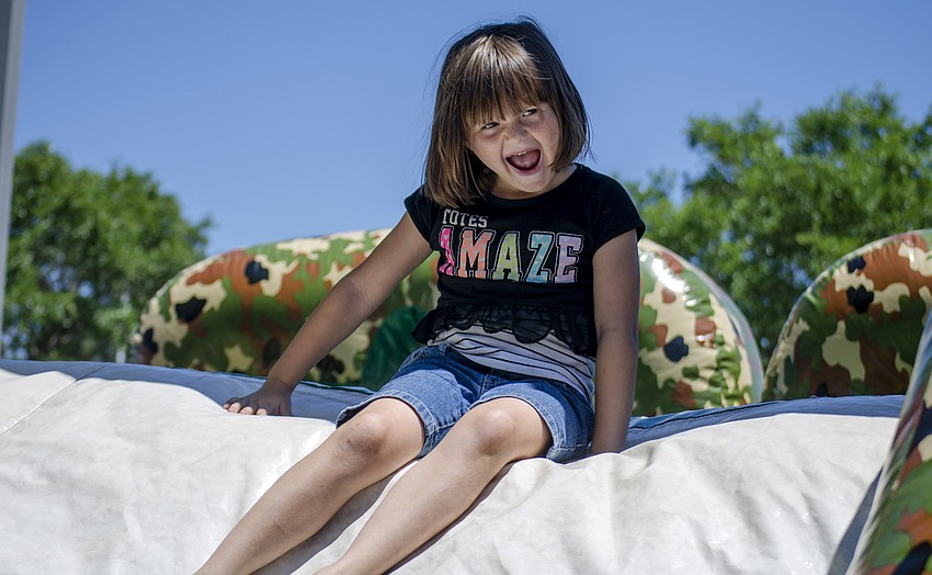 Sarah Edwards plays on one of the inflatable obstacle courses at St. Martha Catholic School'    s Cajun Crawfish and Seafood Festival
