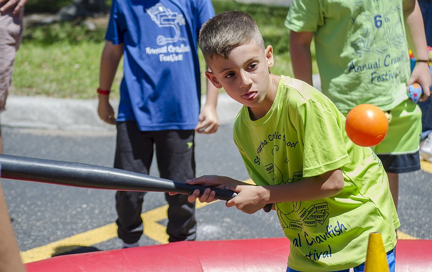 Luca Tucci plays a baseball game at St. Martha Catholic School'    s Cajun Crawfish and Seafood Festival
