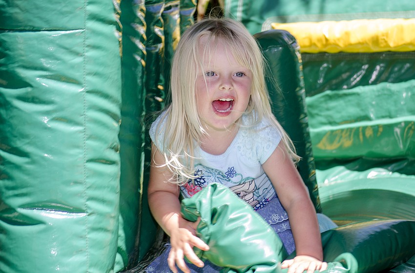 Bea Glassmoyer plays in a inflatable obstacle course during St. Martha Catholic School'    s Cajun Crawfish and Seafood Festival.