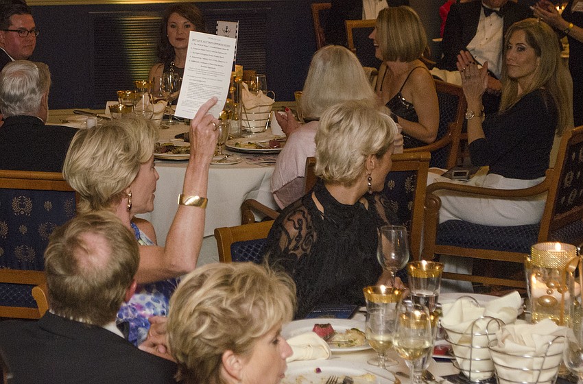 Kimberly Carreiro places a bid during the live auction at  SPARCCle Gala: “A Nautical Night” on April 8 at Bird Key Yacht Club.