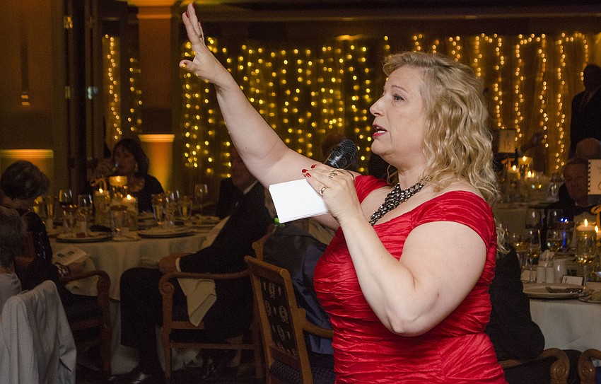 Auctioneer Jenelle Taylor begins the live auction at SPARCCle Gala: “A Nautical Night” on April 8 at Bird Key Yacht Club.