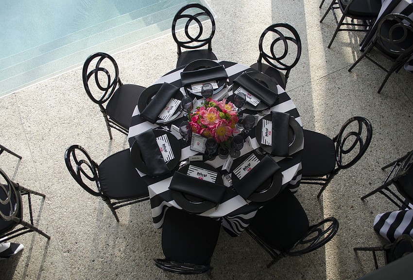 Asolo Repertory Theatre Special Events Manager Laura Stuart Wood designed the table settings with a black and white theme with pops of color at Starry Night Dinner 3 on April 17 at the home of Elaine and Bill Crouse.
