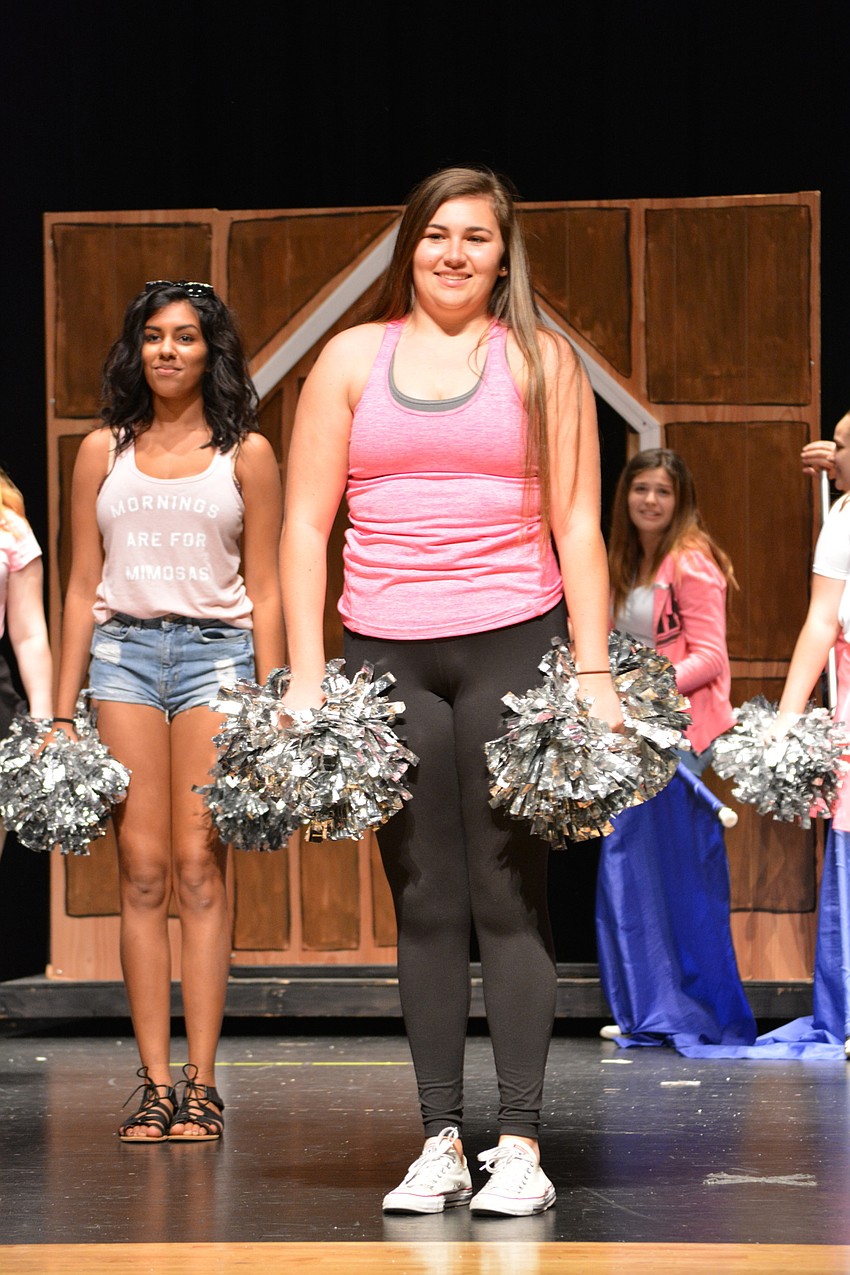 Alexis Reis, center, supports Elle as she gives her Harvard 