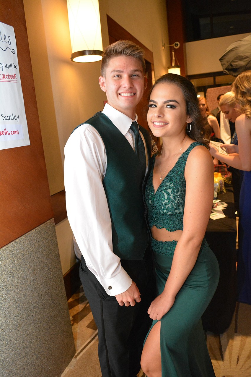 Lakewood senior Marco Zimmerman stands in line for photos with his date, Danielle Campbell.