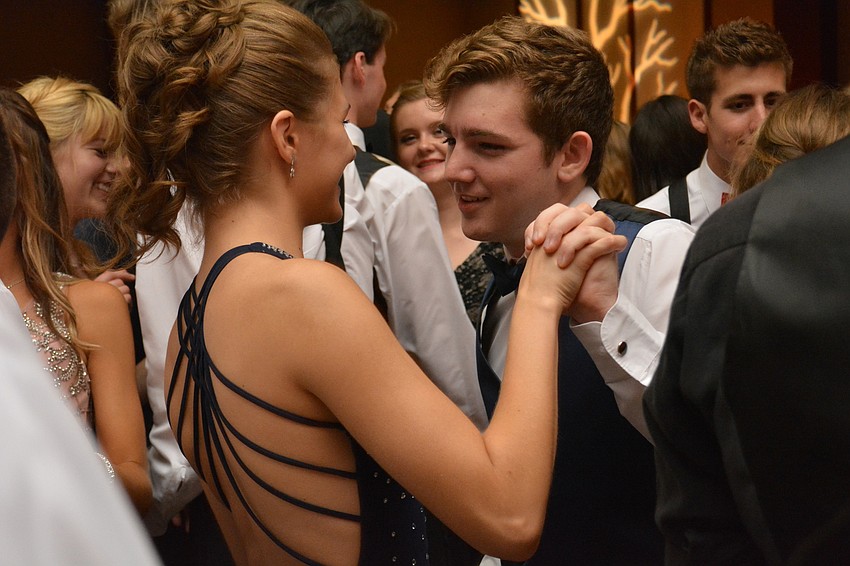 Kellie Fallon and Trent Sunderman eventually danced off the main floor to avoid the crowd during Lakewood'   s prom.