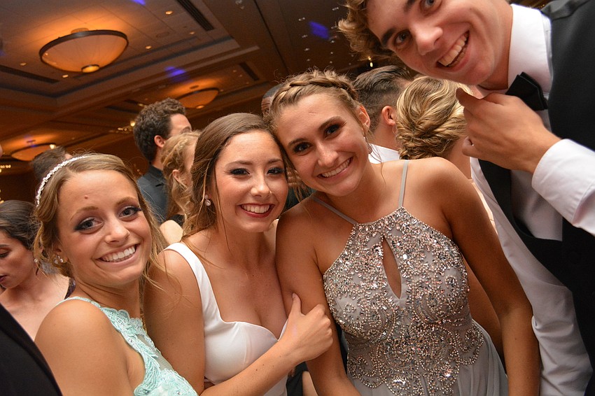 Olivia Danko, Denali Schappacher, Abby Misiura and Brock Sisson dance close to the disc jockey during Lakewood'   s prom.