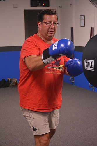 Michael Roy throws punches during his Rock Steady Boxing class.
