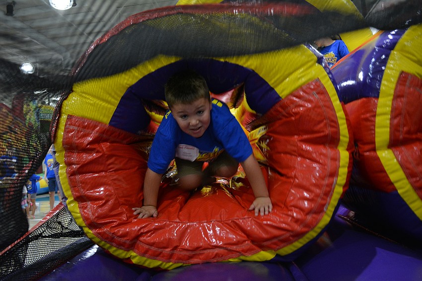 Owen Scheuer tests his skills on an inflatable obstacle course.