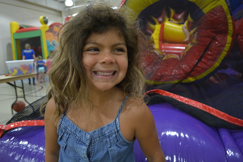 Emma Jones, 5, is all smiles after completing an inflatable obstacle course.