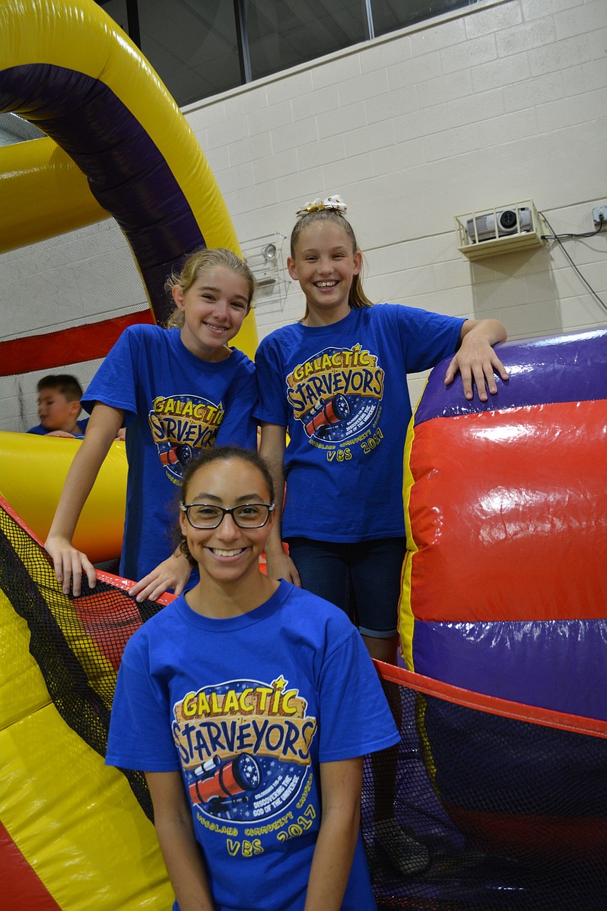 Clockwise from front: Hannah McFarland, Hannah Bolton and Ellie Barker help manage children on the inflatable obstacle course.