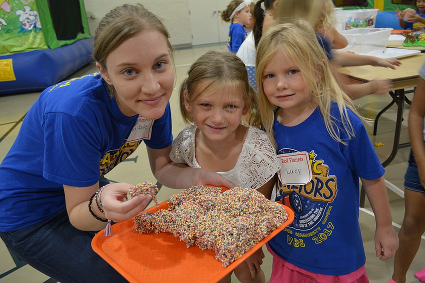 Counselor Kylie Daniel pretends to eat a 