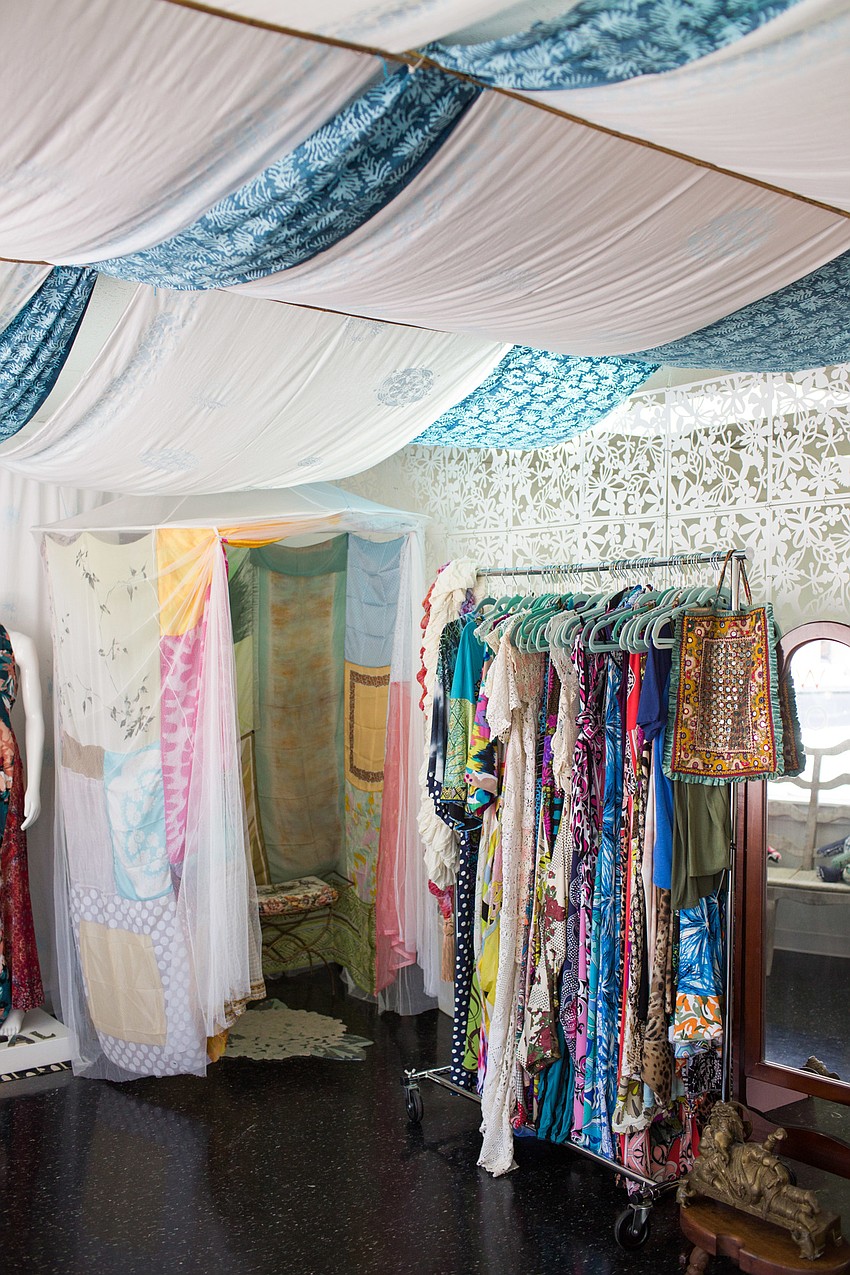 Mara's store is bright and inviting and filled with racks of colorful clothes.