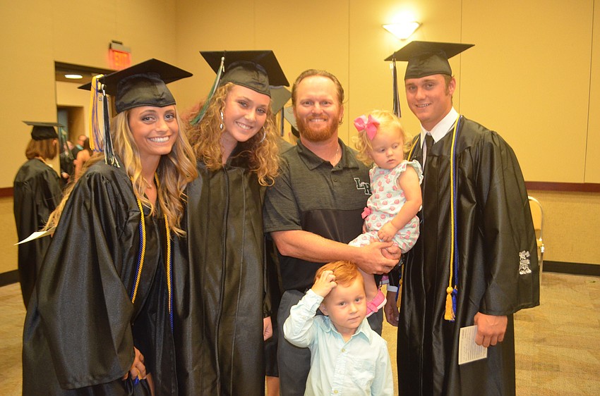 Olivia Danko, Morgan Cummins, coach Ryan Kennedy, Lorela Kennedy, 1, Ryker Kennedy, 4, and Justin Curtis say goodbye.