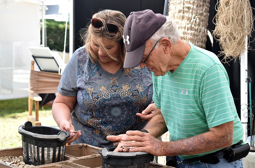 Karen Dodgett and Bob Thomas look at stone work by Thomas.