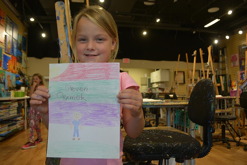 Meredith Organek, a 7-year-old Robert E. Willis Elementary student, says the thing she loves most about her  dad, Steven Organek, is that he does art with her.
