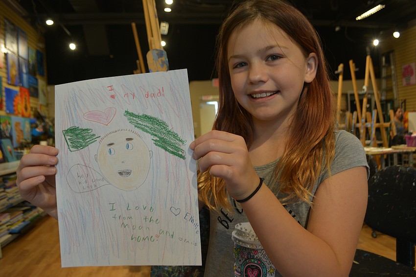 Emilie Roach, a 10-year-old B.D. Gullett Elementary student, says the best thing about her dad, Michael Roach, is that he has tickle fights with her.